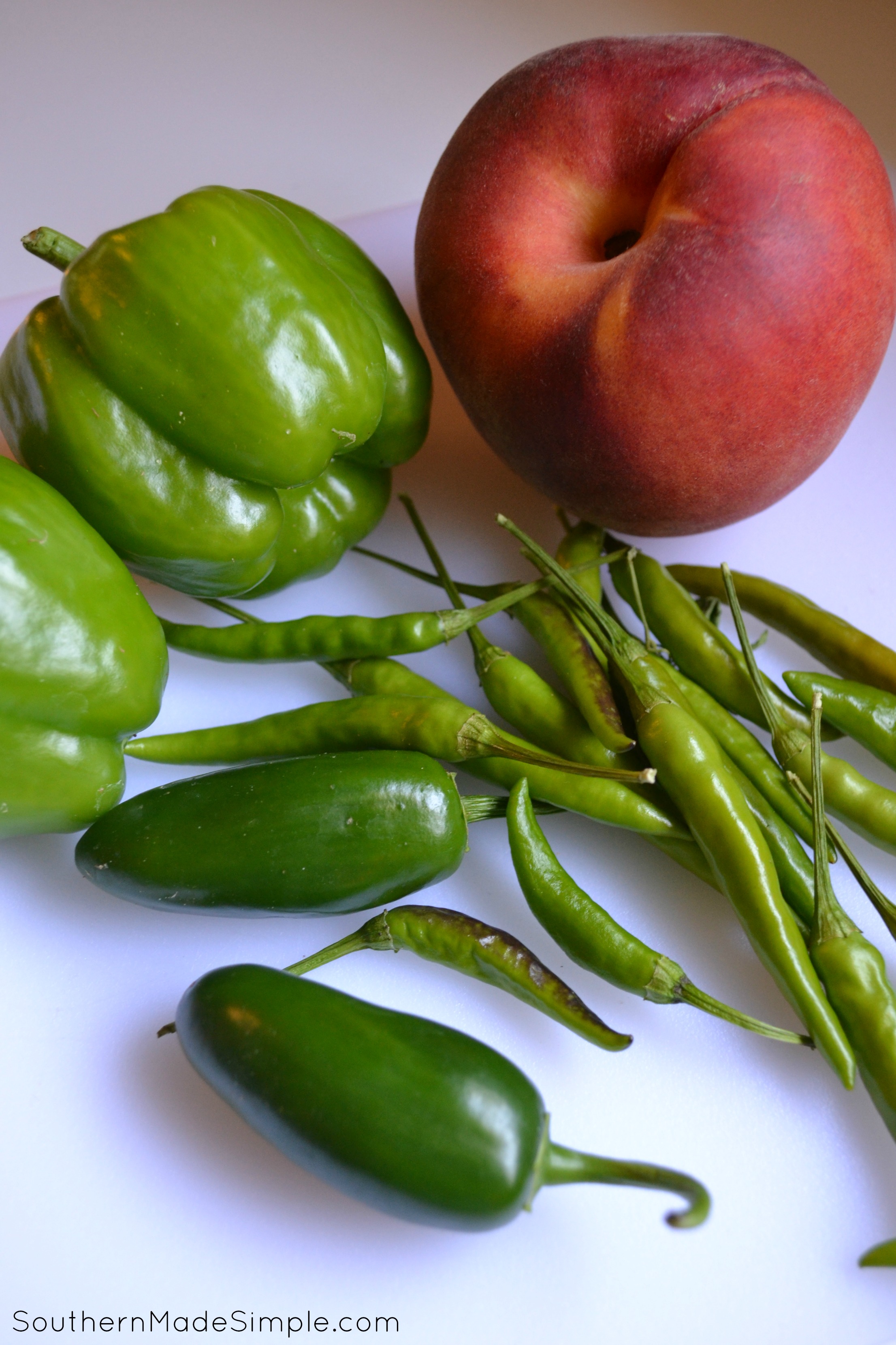 Jalapeno Peach Pepper Jelly - This recipe uses 3 different type of peppers, but you can easily substitute them to whatever you like. It has the perfect amount of heat and is AMAZING on just about anything!