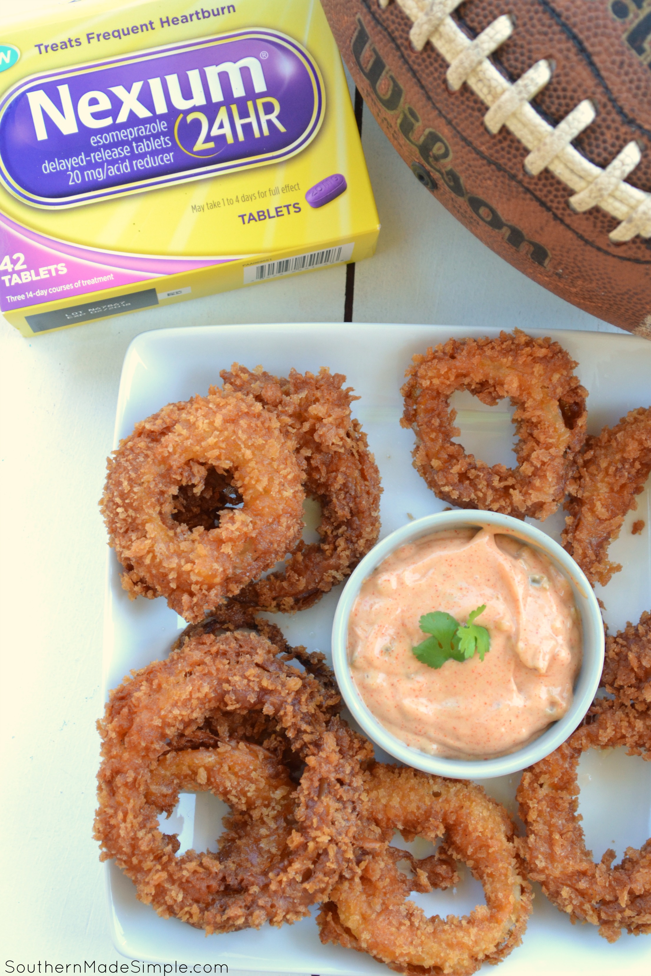 Looking for a winning game day snack that's going to pack a punch and bring the heat? These Smokin' Spicy Onion Rings with a homemade sweet heat dipping sauce are a total game changer, and the perfect way to spice up your game day! #Tailgreatness #ad 