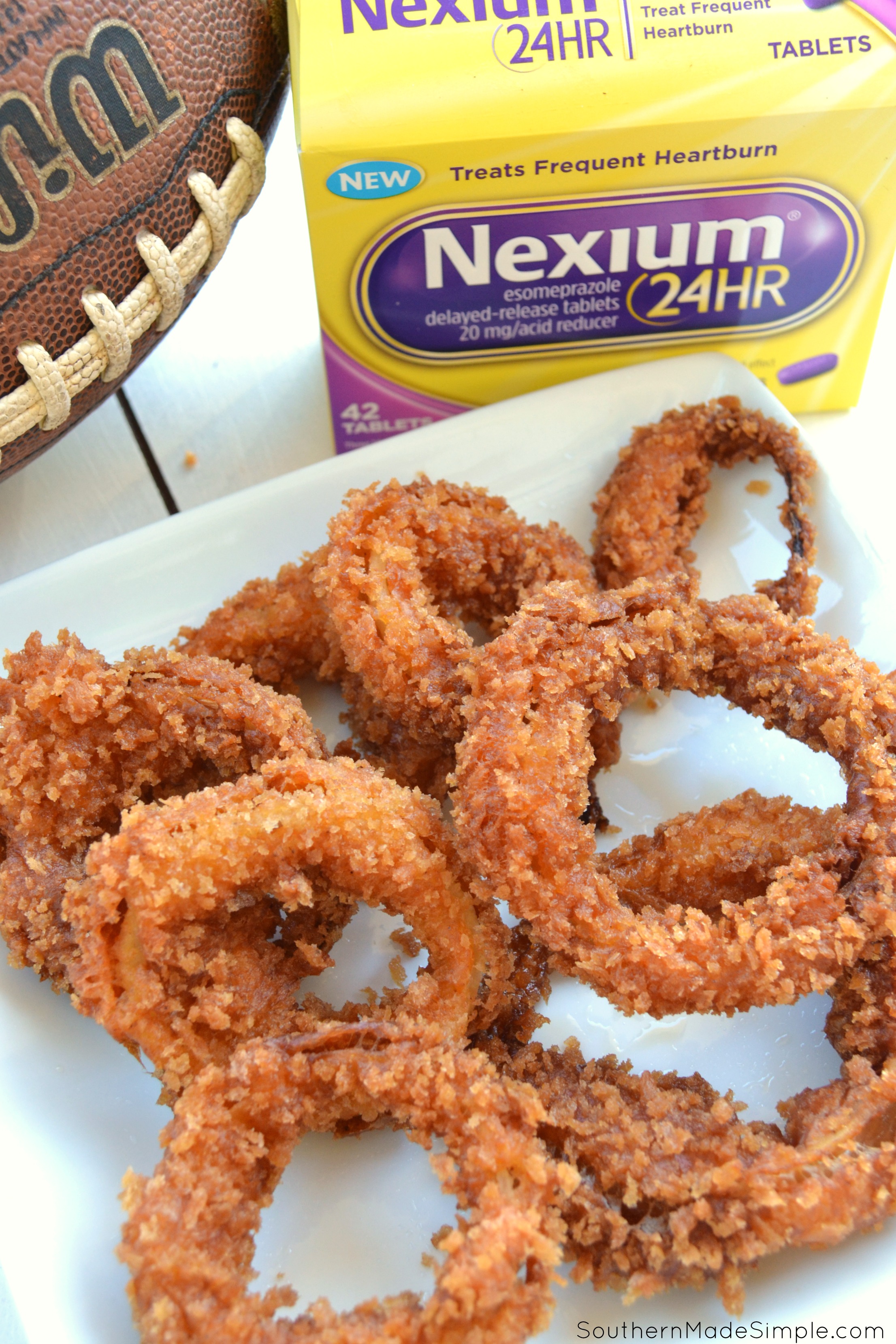 Looking for a winning game day snack that's going to pack a punch and bring the heat? These Smokin' Spicy Onion Rings with a homemade sweet heat dipping sauce are a total game changer, and the perfect way to spice up your game day! #Tailgreatness #ad 