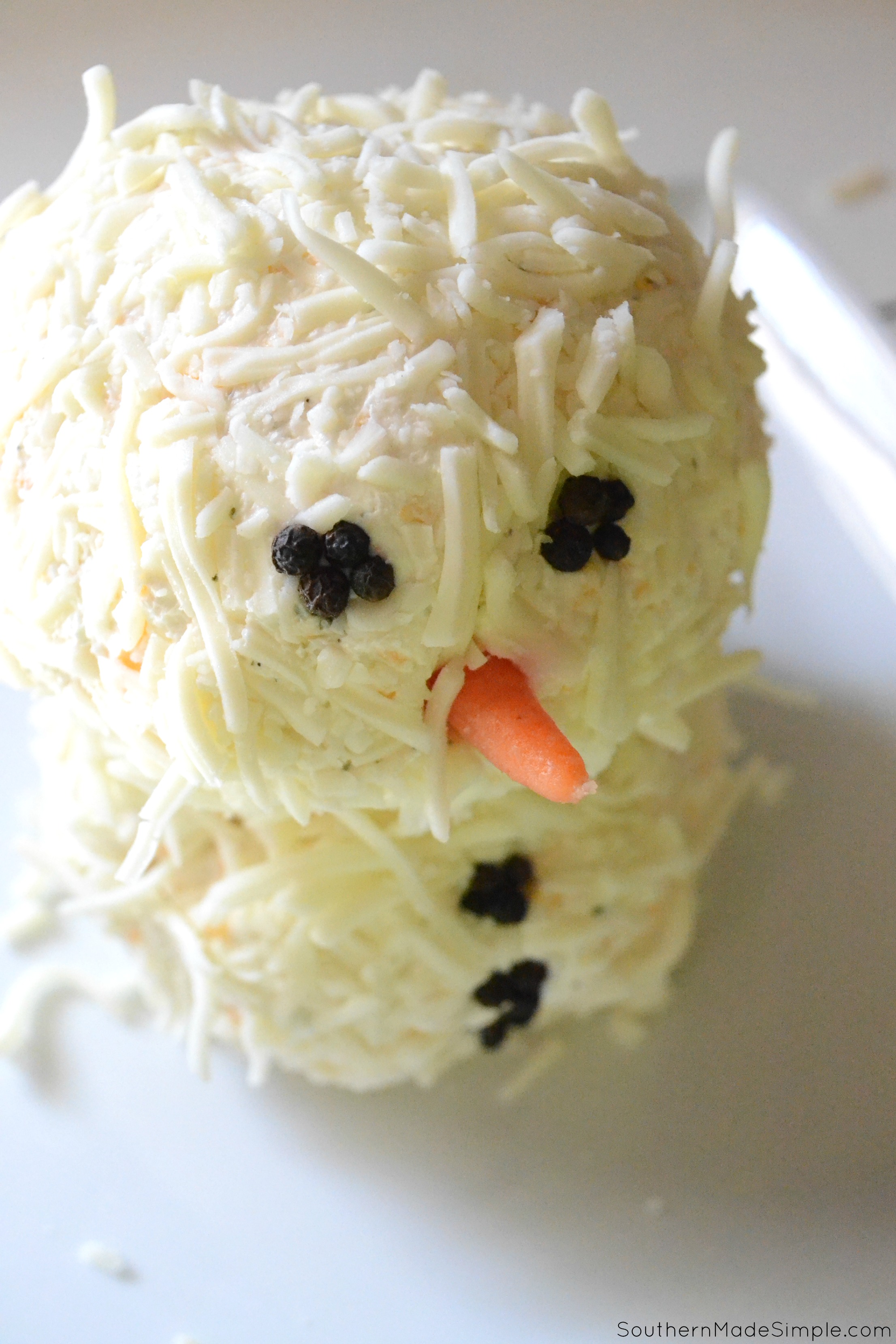 Looking for something simple and cute to take to a holiday party? This Snowman Cheese Ball paired with Ritz Crackers is a perfect choice! #HolidayRITZ #ad