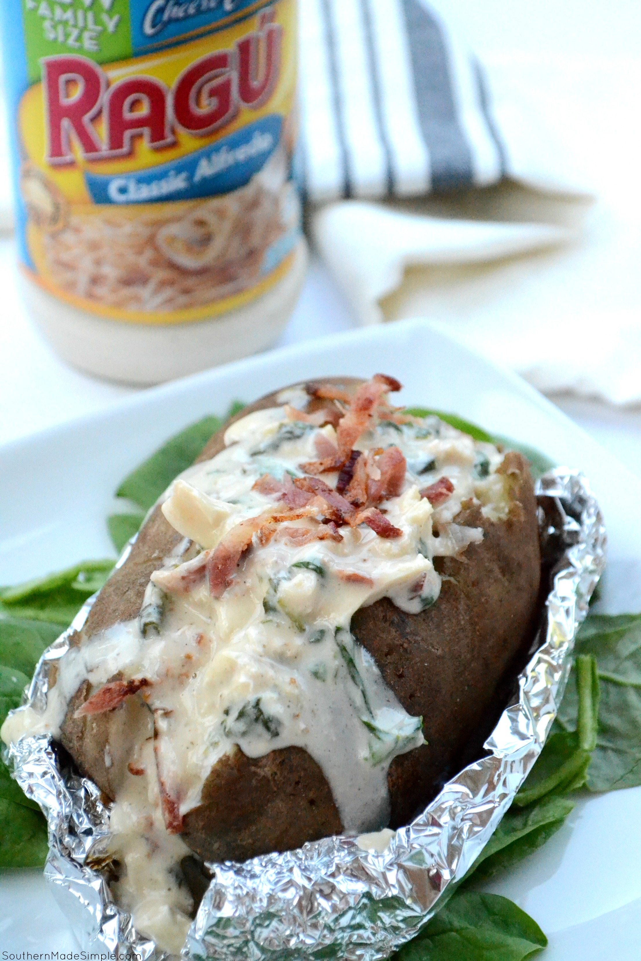 There's nothing better than a baked potato loaded with delicious cheesy goodness, and these Cheesy Chicken & Spinach Alfredo Baked Potatoes are overflowing with the the creamiest alfredo sauce made by Ragu that will make you go back for seconds!