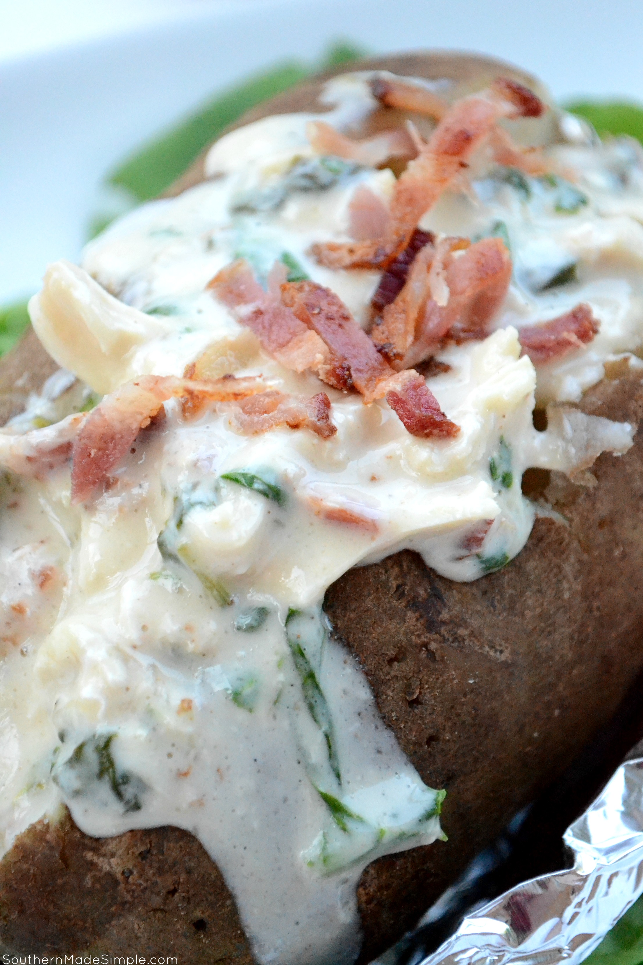 There's nothing better than a baked potato loaded with delicious cheesy goodness, and these Cheesy Chicken & Spinach Alfredo Baked Potatoes are overflowing with the the creamiest alfredo sauce made by Ragu that will make you go back for seconds!