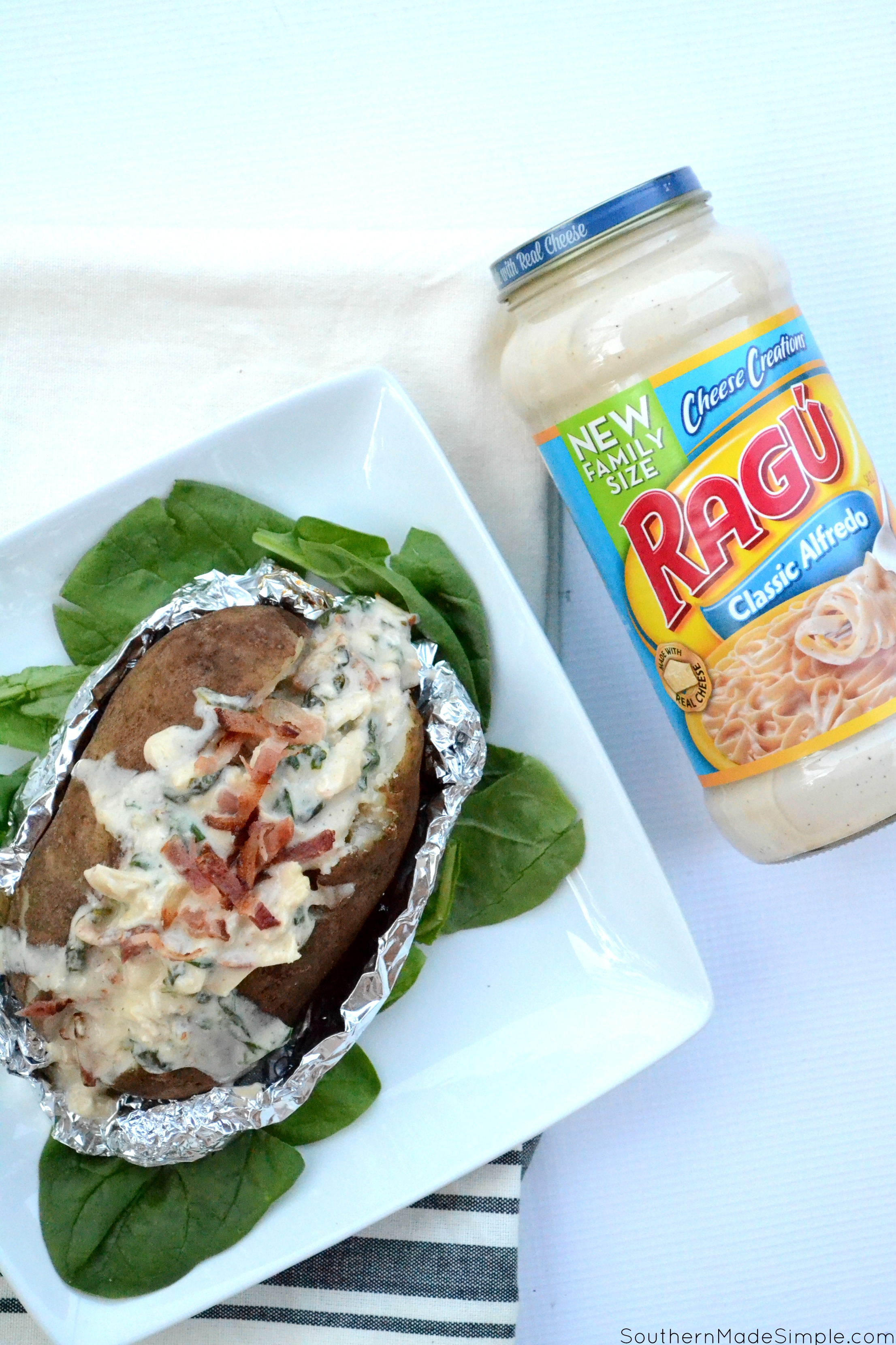 There's nothing better than a baked potato loaded with delicious cheesy goodness, and these Cheesy Chicken & Spinach Alfredo Baked Potatoes are overflowing with the the creamiest alfredo sauce made by Ragu that will make you go back for seconds!