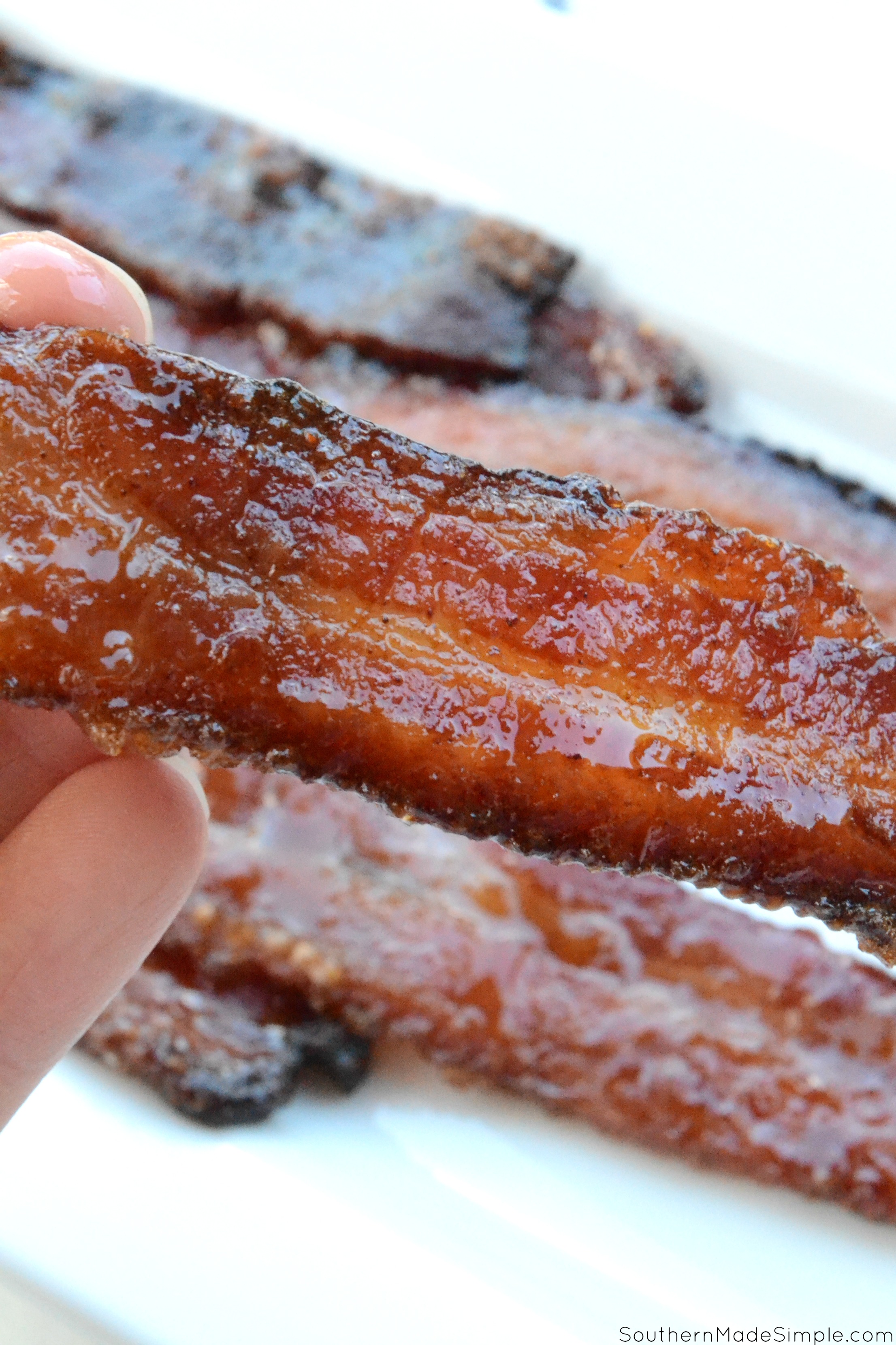 This super simple recipe for sweet and savory candied bacon with a hint of heat is so finger lickin' good, you'll want to make it all the time!