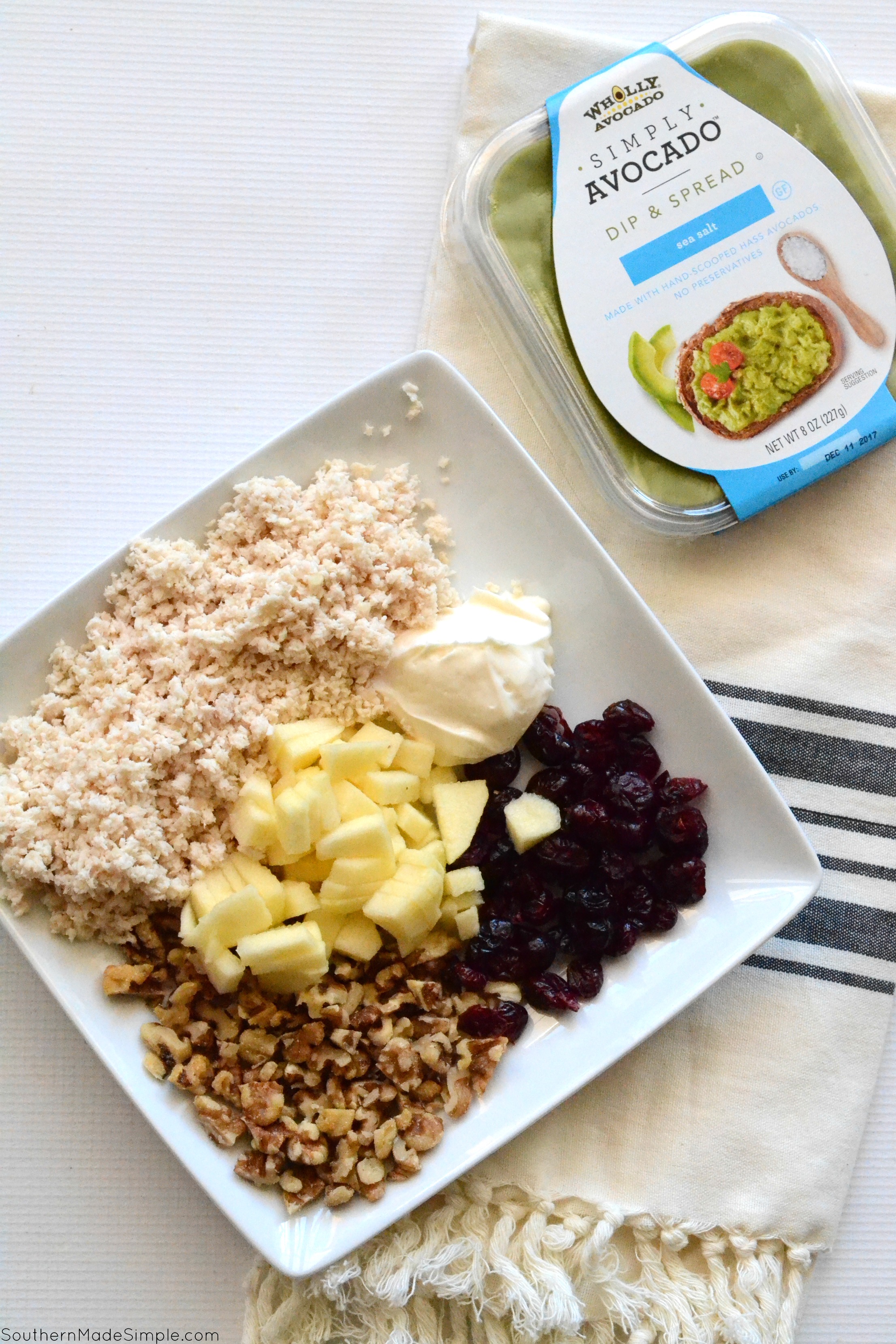 Need a quick and easy mid-day snack or a simple lunch on the go packed with goodness? This recipe for Cranberry-Avocado Chicken Salad is light, delicious and can come together in just a few minutes! Serve it on apple slices, with crackers, in a tortilla or on bread, the possibilities are endless! #SimplyAvocado #Ad
