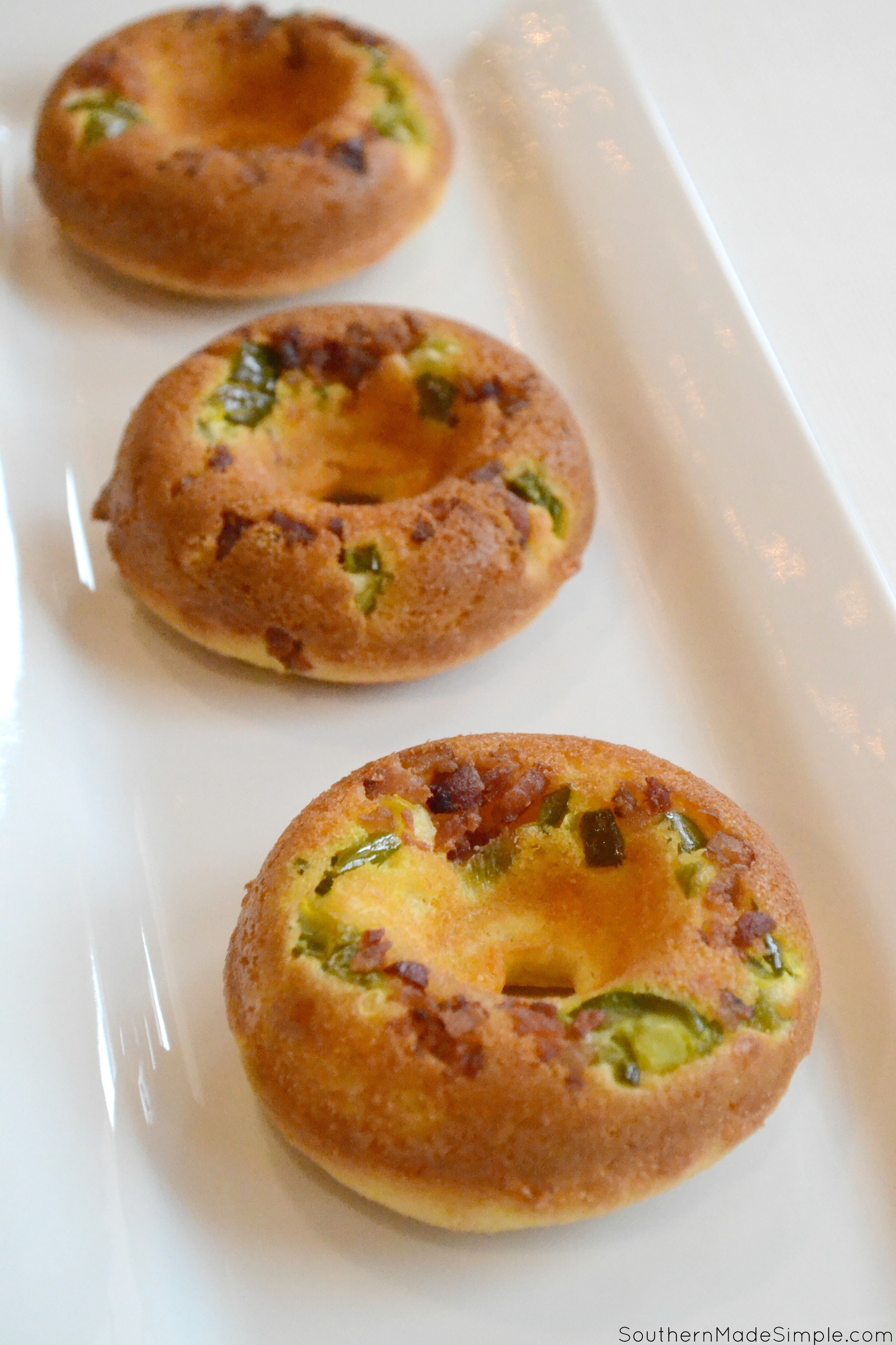 Serve up some spicy goodness during the big game with these savory Cheddar Bacon Jalapeno Doughnuts! They're a cheesy cornbread base with a spicy jalapeno cheese sauce that is in a league of it's own! Pair it with an ice cold Coca-Cola and you've got a winning hand! #ServeWithACoke #BowlGames #CollectiveBias