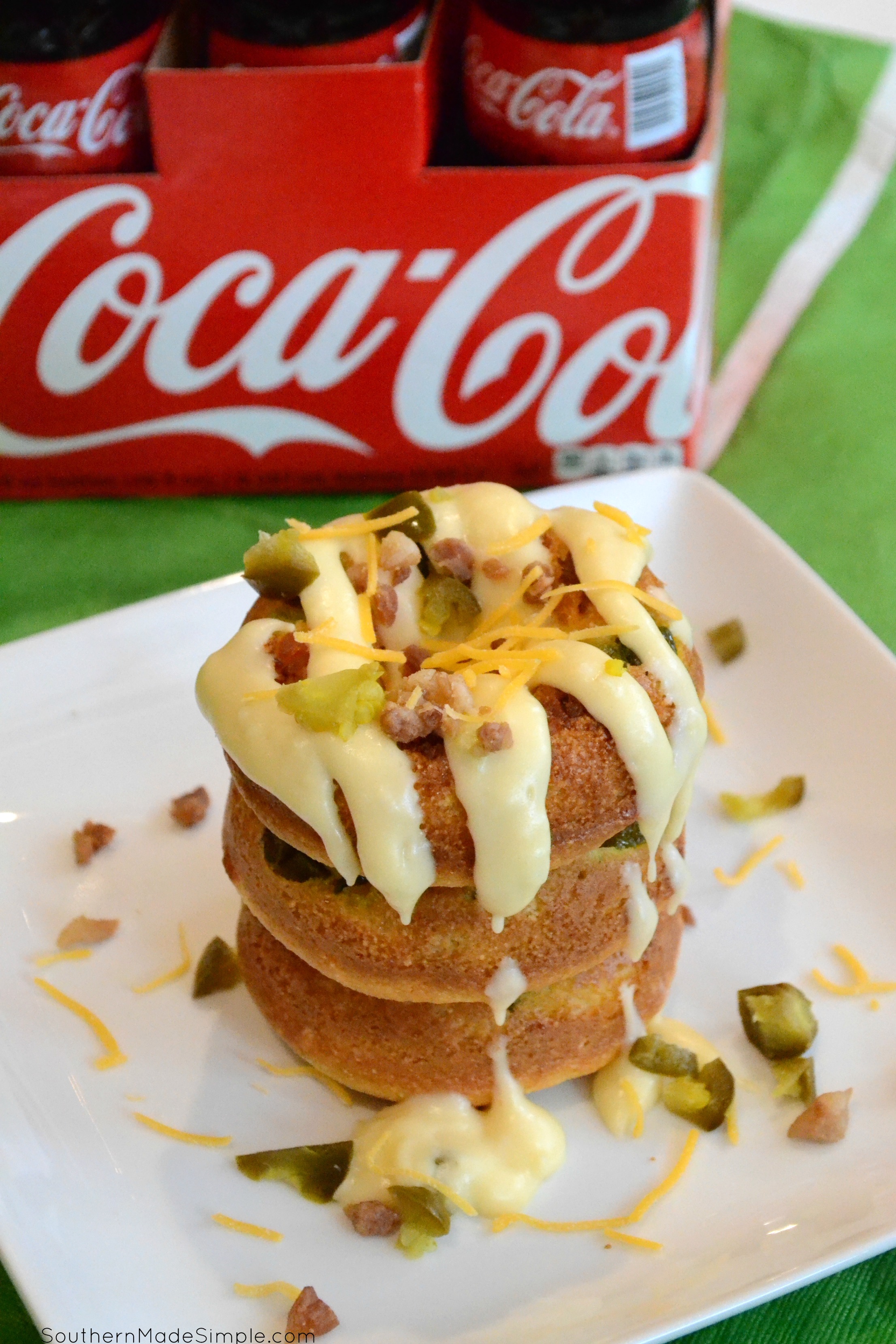 Serve up some spicy goodness during the big game with these savory Cheddar Bacon Jalapeno Doughnuts! They're a cheesy cornbread base with a spicy jalapeno cheese sauce that is in a league of it's own! Pair it with an ice cold Coca-Cola and you've got a winning hand! #ServeWithACoke #BowlGames #CollectiveBias