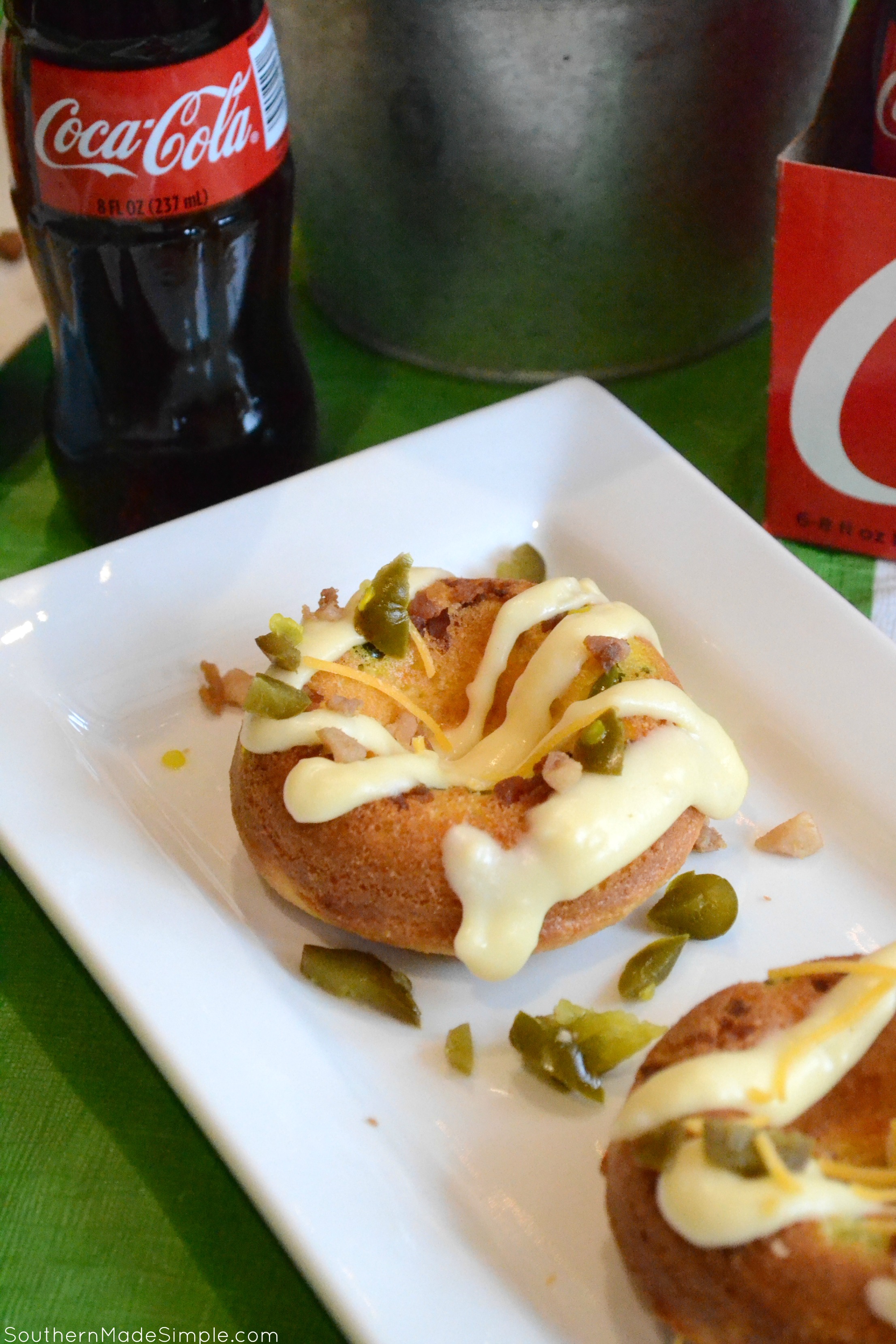 Serve up some spicy goodness during the big game with these savory Cheddar Bacon Jalapeno Doughnuts! They're a cheesy cornbread base with a spicy jalapeno cheese sauce that is in a league of it's own! Pair it with an ice cold Coca-Cola and you've got a winning hand! #ServeWithACoke #BowlGames #CollectiveBias