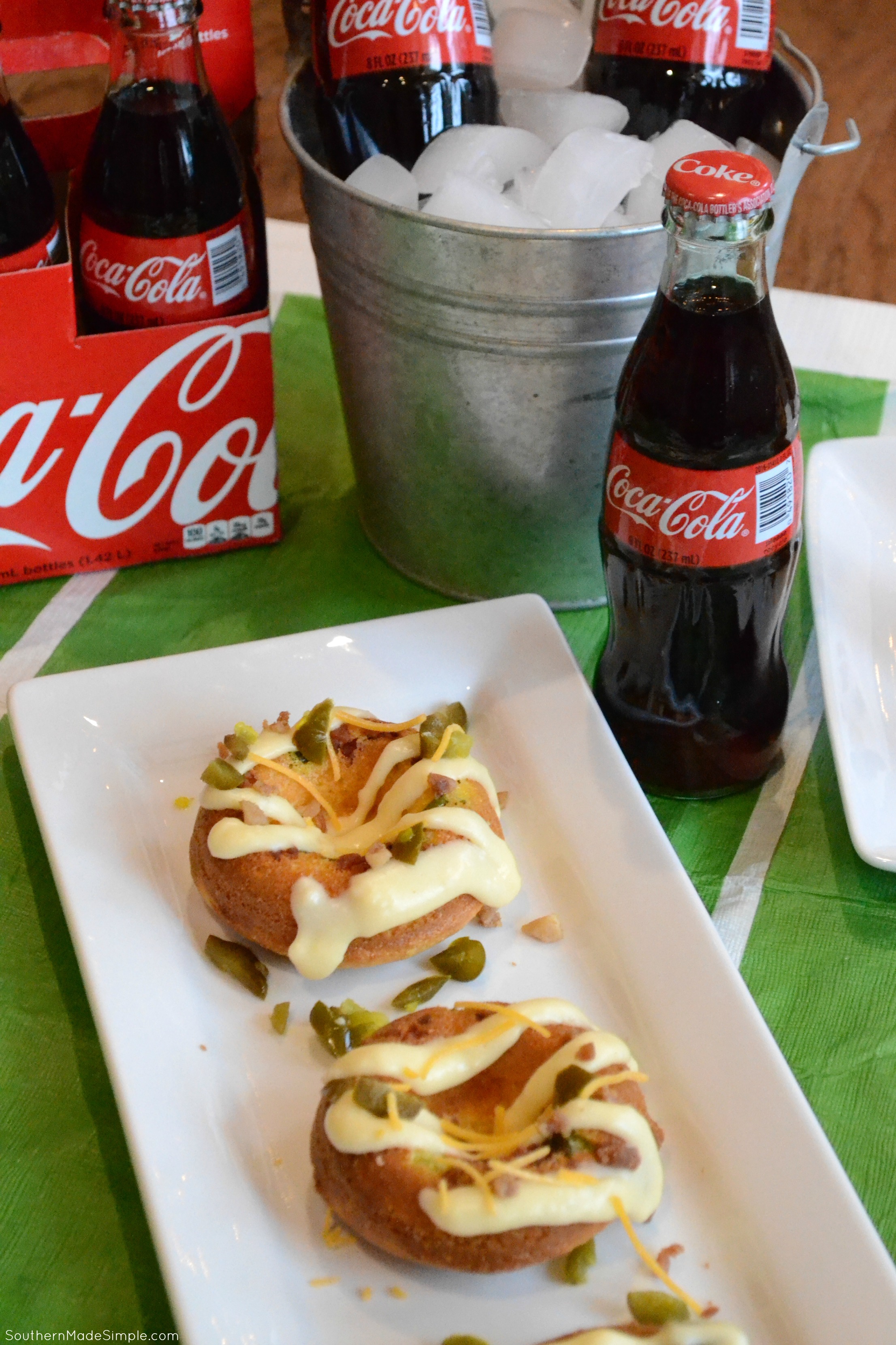 Serve up some spicy goodness during the big game with these savory Cheddar Bacon Jalapeno Doughnuts! They're a cheesy cornbread base with a spicy jalapeno cheese sauce that is in a league of it's own! Pair it with an ice cold Coca-Cola and you've got a winning hand! #ServeWithACoke #BowlGames #CollectiveBias