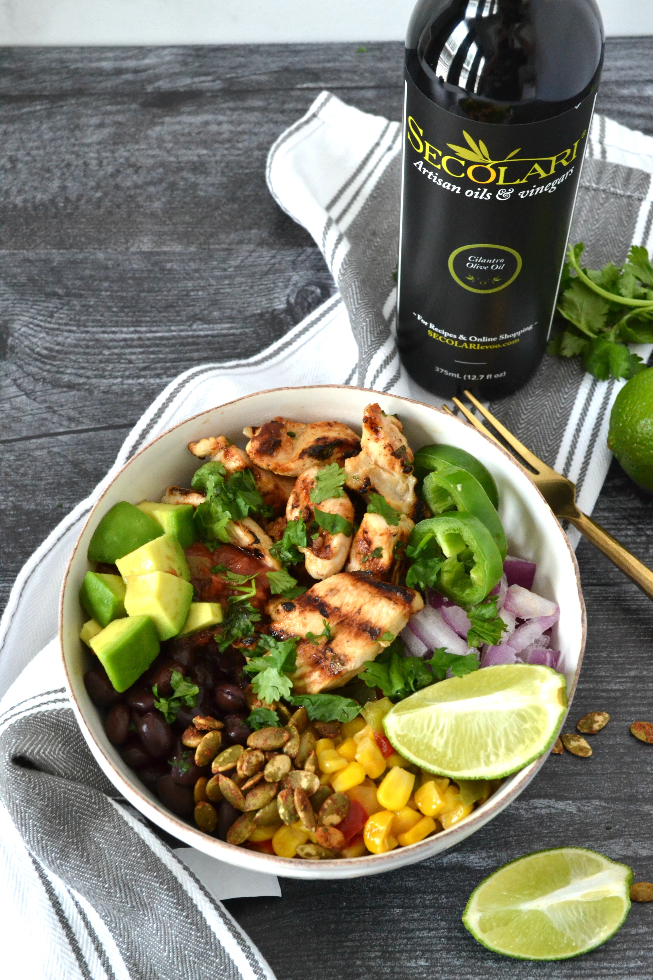 Cilantro Lime Chicken Taco Bowls are a perfect weeknight meal to celebrate your favorite night of the week: Taco Tuesday! Using Secolari Artisan Cilantro Olive Oil, the rich flavors of pressed cilantro in the grilled chicken really come to life! #ad 