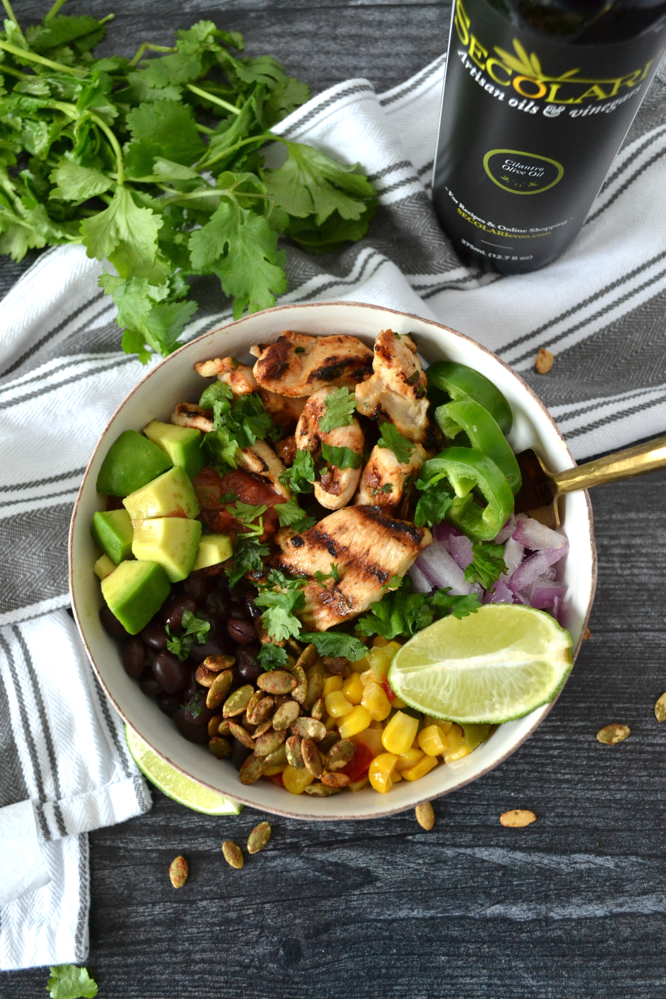 Cilantro Lime Chicken Taco Bowls are a perfect weeknight meal to celebrate your favorite night of the week: Taco Tuesday! Using Secolari Artisan Cilantro Olive Oil, the rich flavors of pressed cilantro in the grilled chicken really come to life! #ad 